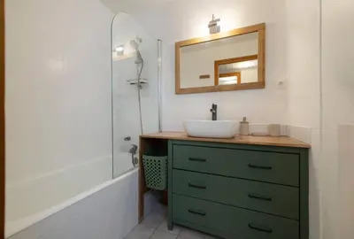 a bathroom with a sink and a mirror and a tub at Cozy Sleeps 4 Mountain view 300m lift in Chamonix-Mont-Blanc