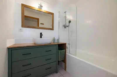 a bathroom with a sink and a mirror and a tub at Cozy Sleeps 4 Mountain view 300m lift in Chamonix-Mont-Blanc