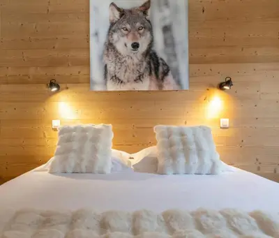 a picture of a wolf hanging above a bed at Cozy Sleeps 4 Mountain view 300m lift in Chamonix-Mont-Blanc