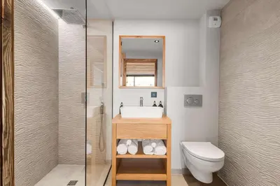 a bathroom with a sink and a toilet and a mirror at Chalet Rémond - Vue Montagnes in Chamonix-Mont-Blanc