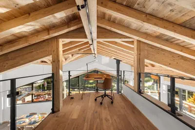 an office with wooden ceilings and a desk in a room with windows at Chalet Rémond - Vue Montagnes in Chamonix-Mont-Blanc