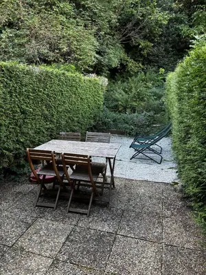 a wooden table and chairs on a patio at Triplex de 42m2 proche piste retour de St-Gervais in Saint-Gervais-les-Bains