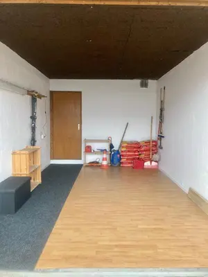 an empty room with a wooden floor and a door at Triplex de 42m2 proche piste retour de St-Gervais in Saint-Gervais-les-Bains