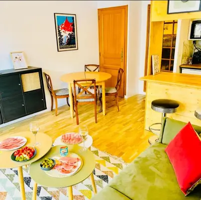 a living room with two tables and a couch at Bright apartment in the heart of Chamonix in Chamonix-Mont-Blanc