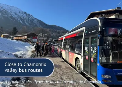 a group of people standing next to a bus at Les Grands Tetras in Les Houches