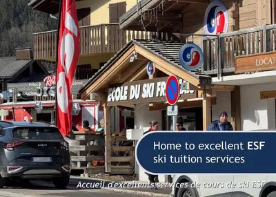 a car parked in front of a building with a sign at Les Grands Tetras in Les Houches