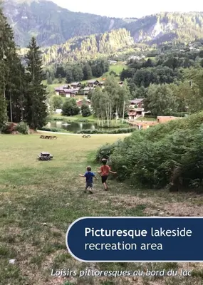 two children are standing in a field with a mountain at Les Grands Tetras in Les Houches