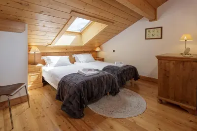 a bedroom with two beds and a skylight at Les Sonnailles Apartment - Chamonix All Year in Chamonix-Mont-Blanc
