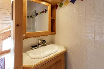 a bathroom with a sink and a mirror at Les Sonnailles Apartment - Chamonix All Year in Chamonix-Mont-Blanc