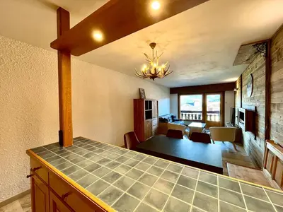 a kitchen and living room with a dining room at The Balcony of the Giant in Combloux in Combloux