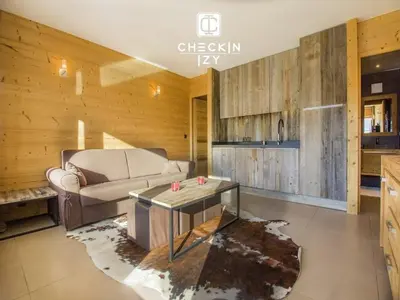 a living room with a couch and a table at Studio cabine cosy Megève parking gratuit in Megève