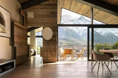 a dining room with a view of mountains at Sumptuous Chalet In Chamonix-Mont-Blanc in Chamonix-Mont-Blanc