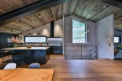 a kitchen with a wooden ceiling and a table at Sumptuous Chalet In Chamonix-Mont-Blanc in Chamonix-Mont-Blanc