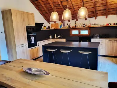 a kitchen with a blue island with two bar stools at Maison du Tailleur de Pierre, 5 bedroom apartment, 3 bathrooms, ski-bus, parking in Samoëns