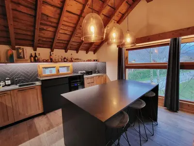 a kitchen with a black counter top and a window at Maison du Tailleur de Pierre, 5 bedroom apartment, 3 bathrooms, ski-bus, parking in Samoëns