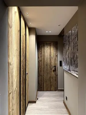 a hallway with wooden walls and a wooden door at Appartement cosy proche du centre de Megève in Megève