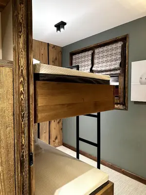 a bunk bed in a room with a window at Appartement cosy proche du centre de Megève in Megève
