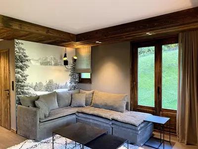 a living room with a couch and a table at Appartement cosy proche du centre de Megève in Megève