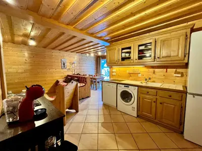 a kitchen with a refrigerator and a washing machine at Confortable T2 avec jardin, animaux acceptés - FR-1-624-188 in Samoëns