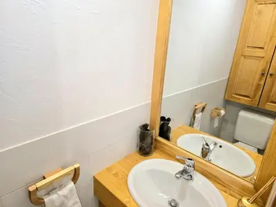 a bathroom with a sink and a mirror at Charming sunny duplex in Megève