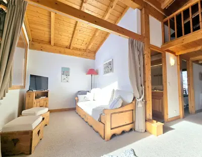 a bedroom with a bed and a television at Charming sunny duplex in Megève