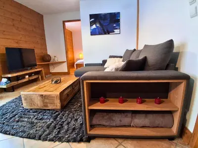 a living room with a couch and a coffee table at CoconAlpin au coeur de la station in Arâches-la-Frasse
