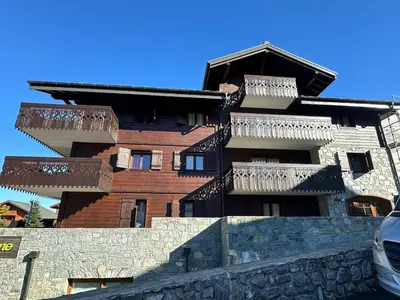a building with balconies on the side of it at CoconAlpin au coeur de la station in Arâches-la-Frasse