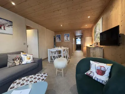a living room with two couches and a table at Le Grison in Megève