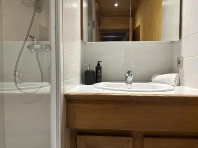 a bathroom with a sink and a shower at Le Grison in Megève