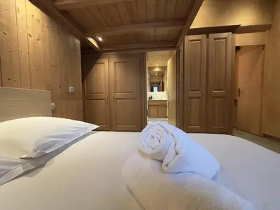 a bedroom with a bed with a towel on it at Le Grison in Megève