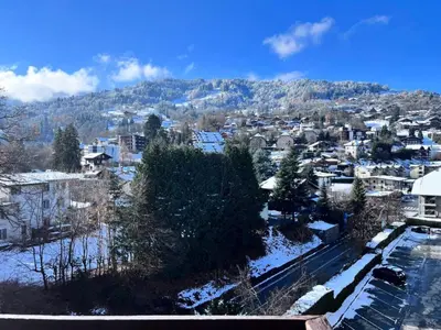 a snow covered city with a mountain in the background at Résidence Castel Des Roches C - CASTEL DES ROCHES C57 MAE-3063 in Saint-Gervais-les-Bains