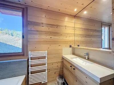a bathroom with wooden walls and a sink and a window at Chalet spacieux 5 chambres proche ski bus, vue Mont-Blanc - FR-1-560-172 in Combloux