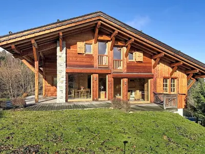 a large wooden house with a large porch at Chalet spacieux 5 chambres proche ski bus, vue Mont-Blanc - FR-1-560-172 in Combloux