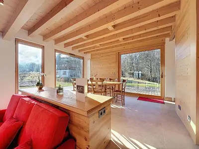 a living room with a red couch and a table at Chalet spacieux 5 chambres proche ski bus, vue Mont-Blanc - FR-1-560-172 in Combloux
