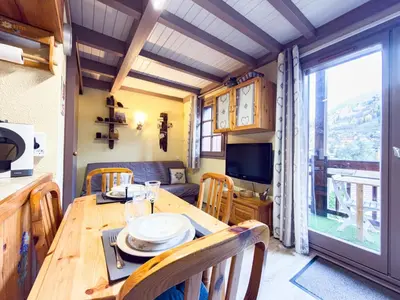 a dining room with a table and a large window at Le Nid du Mont Joly, Mountain View et Parking in Saint-Gervais-les-Bains