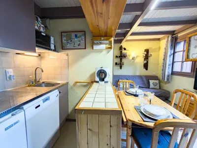 a small kitchen with a table and a sink at Le Nid du Mont Joly, Mountain View et Parking in Saint-Gervais-les-Bains