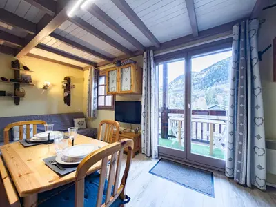 a dining room with a table and a large window at Le Nid du Mont Joly, Mountain View et Parking in Saint-Gervais-les-Bains