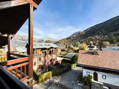 a view of a town with mountains in the background at Le Nid du Mont Joly, Mountain View et Parking in Saint-Gervais-les-Bains