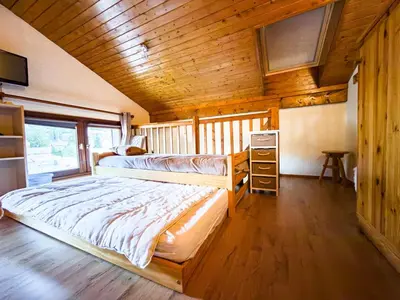 a bedroom with two bunk beds in a cabin at Le Nid du Mont Joly, Mountain View et Parking in Saint-Gervais-les-Bains
