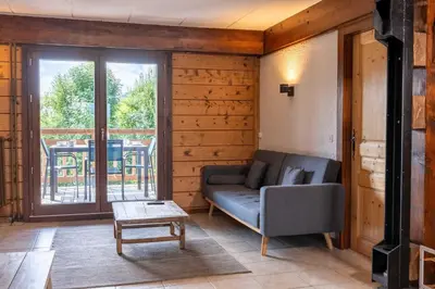 a living room with a couch and a table at 1BDR 4P apartment with balcony and parking- Megève in Megève