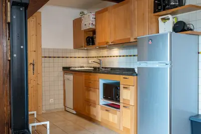 a kitchen with a refrigerator and a sink at 1BDR 4P apartment with balcony and parking- Megève in Megève