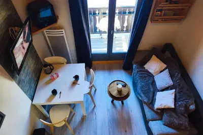 an overhead view of a living room with a couch and a table at Charming apartment with mezzanine in the mountain in Demi-Quartier