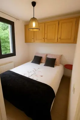 a bedroom with a large white bed with a lamp at Charming apartment with mezzanine in the mountain in Demi-Quartier