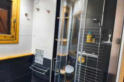 a shower with a glass door in a bathroom at Charming apartment with mezzanine in the mountain in Demi-Quartier