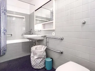 a bathroom with a sink and a toilet and a mirror at Grand studio Flaine Forum vue montagne in Flaine