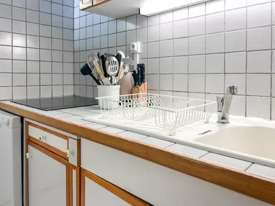 a kitchen counter with a sink and a dish rack at Grand studio Flaine Forum vue montagne in Flaine