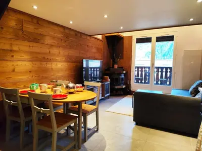 a dining room with a table and a couch at La Kabane d'Orsin 3 étoiles in Saint-Gervais-les-Bains