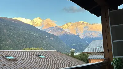 a view of a mountain range from a house at La Kabane d'Orsin 3 étoiles in Saint-Gervais-les-Bains