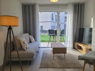 a living room with a couch and a tv at Alpin Les Thermes - Pres Thermes & Tramway in Saint-Gervais-les-Bains