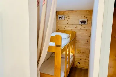 a bunk room with bunk beds in a cabin at Bright apartment with views of Mont Blanc in Chamonix-Mont-Blanc